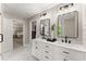 Bright main bathroom offers double sinks, marble countertops, and a glass shower with white subway tile at 6520 Glen Pond Trce, Cumming, GA 30028