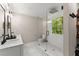 Bright bathroom featuring white subway tile shower and a modern vanity and shelving at 6520 Glen Pond Trce, Cumming, GA 30028