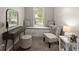 Sitting area featuring a window seat, a vanity with a mirror, and a comfortable chair at 6520 Glen Pond Trce, Cumming, GA 30028