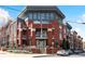 Modern brick condo building featuring multi-level balconies and manicured landscaping at Centennial Station at 89 Mangum St # 210, Atlanta, GA 30313