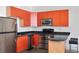 Modern kitchen features stainless steel appliances, vibrant cabinetry, and a breakfast bar at 89 Mangum St # 210, Atlanta, GA 30313