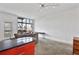 Open living area features high ceilings, large windows, concrete floors and an attached breakfast bar at 89 Mangum St # 210, Atlanta, GA 30313