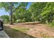 Large grassy lot surrounded by mature trees creates a private and serene outdoor space at 264 Rockin Hill Dr, Marietta, GA 30060
