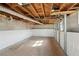 Unfinished basement with concrete floor and exposed wood ceiling offers potential for customization and expansion at 264 Rockin Hill Dr, Marietta, GA 30060