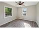 Cozy bedroom with natural light, ceiling fan, and sleek gray flooring at 264 Rockin Hill Dr, Marietta, GA 30060