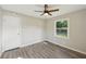 Bright bedroom featuring updated flooring, natural light from a window, and a ceiling fan at 264 Rockin Hill Dr, Marietta, GA 30060
