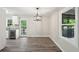 Light and airy dining area with gray floors, contemporary light fixture, and natural light at 264 Rockin Hill Dr, Marietta, GA 30060