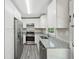 Updated kitchen featuring stainless steel appliances, granite counters, and white cabinetry at 264 Rockin Hill Dr, Marietta, GA 30060