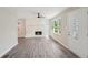 Bright living room featuring stylish gray floors, a white brick fireplace, and abundant natural light at 264 Rockin Hill Dr, Marietta, GA 30060
