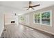 Open-concept living room featuring a brick fireplace, gray flooring and large windows at 264 Rockin Hill Dr, Marietta, GA 30060