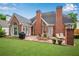 Brick home's backyard features a patio, grill, manicured lawn, and landscaping, ideal for relaxing or entertaining at 350 Declaire Ne Way, Marietta, GA 30067