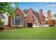 Stunning brick home's backyard boasts a patio, grill, lush lawn, and landscaping, perfect for enjoying the outdoors at 350 Declaire Ne Way, Marietta, GA 30067