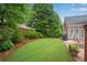 Lush, green backyard featuring a manicured lawn, patio, and mature landscaping, perfect for outdoor entertaining at 350 Declaire Ne Way, Marietta, GA 30067