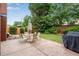 Cozy backyard patio featuring an umbrella-shaded dining set, seating, and a built-in grill for outdoor entertaining at 350 Declaire Ne Way, Marietta, GA 30067