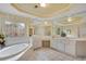 Elegant bathroom featuring a soaking tub, dual vanities, and decorative windows at 350 Declaire Ne Way, Marietta, GA 30067