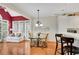 Inviting kitchen and breakfast nook area with white cabinets, bar seating, and large windows at 350 Declaire Ne Way, Marietta, GA 30067