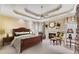 Luxurious main bedroom features a tray ceiling, fireplace, and a cozy sitting area at 350 Declaire Ne Way, Marietta, GA 30067