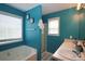 Bright bathroom with blue walls, separate tub, and standing shower at 116 Remington Place Blvd, Dallas, GA 30157