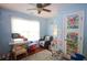 Bright bedroom with a window and a small sitting area with a desk for work or study at 116 Remington Place Blvd, Dallas, GA 30157