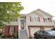 Charming two-story home featuring gray siding, brick accents, red shutters, and an inviting front entrance with a glass paneled door at 116 Remington Place Blvd, Dallas, GA 30157