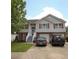 Inviting two-story home showcases a well-manicured lawn, neutral siding, brick facade and red shutters, with a two-car garage at 116 Remington Place Blvd, Dallas, GA 30157