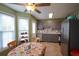 Eat-in kitchen with stainless steel appliances, gray cabinets and a breakfast nook with lots of light from surrounding windows at 116 Remington Place Blvd, Dallas, GA 30157