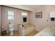 Bright bathroom includes a window and tub and toilet at 2261 Ravenwood Trl, Marietta, GA 30066