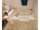 Close up of bath tub with mounted faucet and patterned tile flooring at 2261 Ravenwood Trl, Marietta, GA 30066