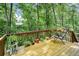 Deck and outdoor seating area surrounded by mature trees and greenery at 2261 Ravenwood Trl, Marietta, GA 30066