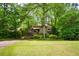 Charming home nestled among lush trees with a two-car garage and inviting front yard at 2261 Ravenwood Trl, Marietta, GA 30066