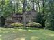 Two-story home with neutral siding and lush landscaping, nestled among mature trees at 2261 Ravenwood Trl, Marietta, GA 30066