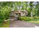 Exterior view showcasing a home with a two-car garage and mature landscaping at 2261 Ravenwood Trl, Marietta, GA 30066