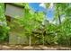 Back exterior view of home surrounded by mature trees and lush greenery at 2261 Ravenwood Trl, Marietta, GA 30066