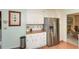 Kitchen features white cabinets, stainless steel refrigerator and view to another room at 2261 Ravenwood Trl, Marietta, GA 30066