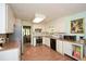 The kitchen features white cabinets, modern appliances, and wood-look flooring at 2261 Ravenwood Trl, Marietta, GA 30066