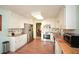 Well-lit kitchen with white cabinets, wood countertops, stainless steel appliances and wood floor at 2261 Ravenwood Trl, Marietta, GA 30066