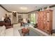 Well-lit carpeted living room with furnishings, wood armoire and sliding door to exterior at 2261 Ravenwood Trl, Marietta, GA 30066