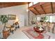 Living room with vaulted wood ceilings and exposed beams, a fan, and neutral colored walls at 2261 Ravenwood Trl, Marietta, GA 30066