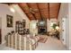 Inviting living room featuring a stone fireplace, vaulted wood ceilings, and bright natural light at 2261 Ravenwood Trl, Marietta, GA 30066