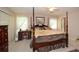 Comfortable bedroom featuring a four-poster bed, light-colored walls and two windows for natural light at 2261 Ravenwood Trl, Marietta, GA 30066