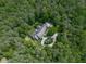 An aerial view that shows a beautiful house surrounded by lush greenery and mature trees at 275 Frances Rd, Canton, GA 30114