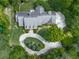 Aerial view of a private home showcasing its well-manicured lawn and a winding driveway at 275 Frances Rd, Canton, GA 30114