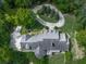 The aerial shot showcases a home with a dark roof and winding driveway at 275 Frances Rd, Canton, GA 30114
