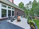 Brick home with an outdoor deck featuring a fire pit and views of the wooded backyard at 275 Frances Rd, Canton, GA 30114