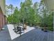Outdoor deck with a cozy fire pit surrounded by lush trees and decorative flower pots at 275 Frances Rd, Canton, GA 30114