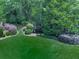 Picturesque backyard with a charming pond, lush landscaping, and a peaceful wooded backdrop at 275 Frances Rd, Canton, GA 30114