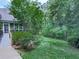 Lush backyard with mature trees, a screened porch, and a wooden walkway at 275 Frances Rd, Canton, GA 30114