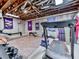Spacious basement exercise area equipped with various fitness machines and exposed ceiling beams at 275 Frances Rd, Canton, GA 30114