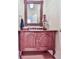 Charming powder room with decorative mirror and a wood vanity with a marble top sink at 275 Frances Rd, Canton, GA 30114