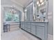 A large primary bathroom with a double sink vanity, standing tub, and a large window at 275 Frances Rd, Canton, GA 30114
